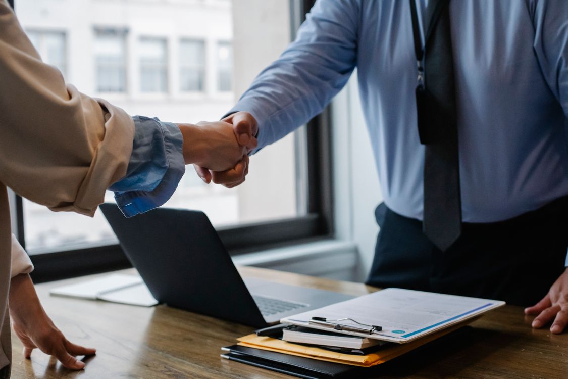 CAMS exam guide - Professional reviewing financial documents and charts at a desk, representing the analytical skills tested in the CAMS exam domains